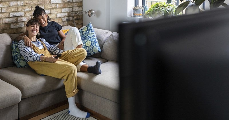 Couple on couch watching tv